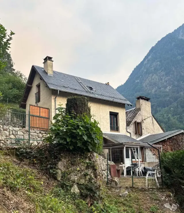 Couverture en ardoise d'une maison béarnaise, avec fenêtre de toit et souche de cheminée